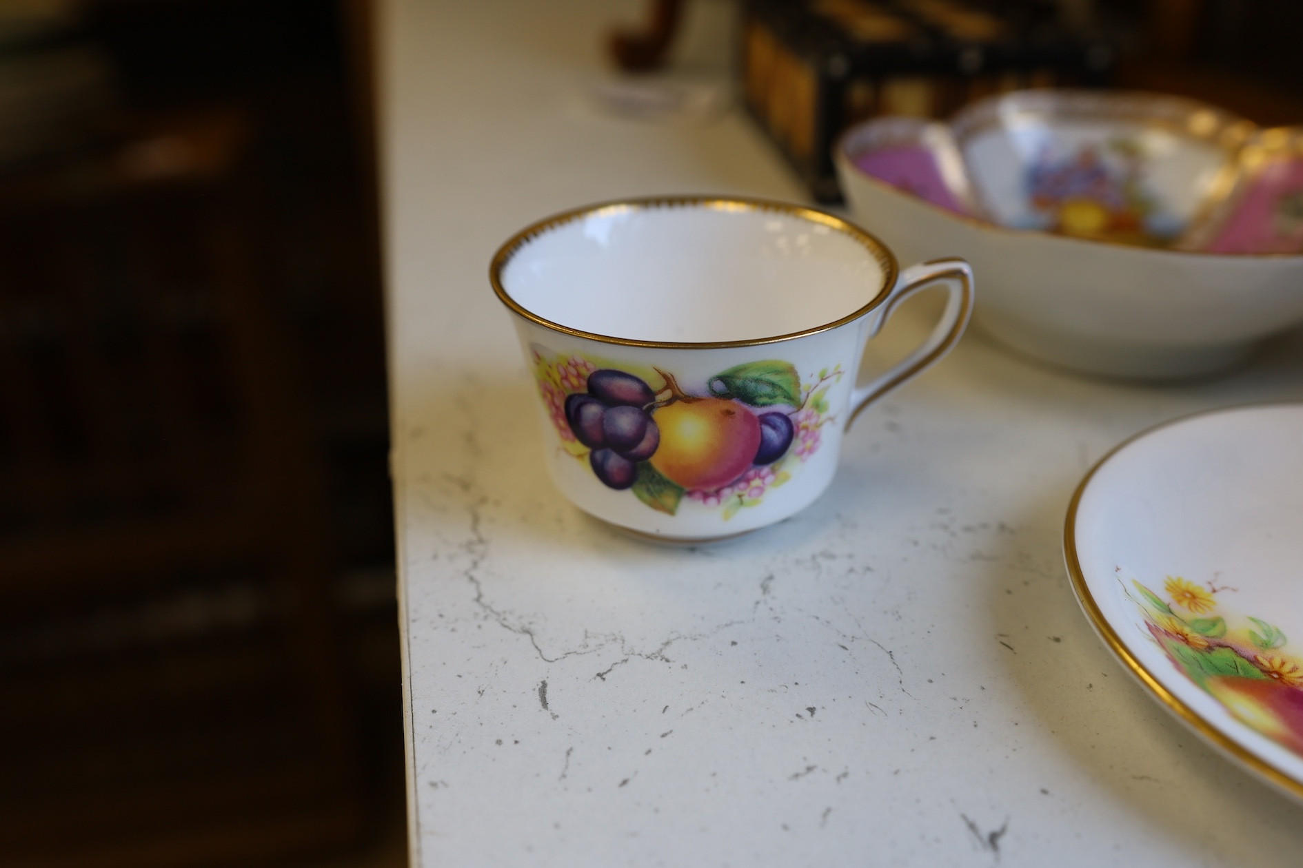 A Wedgwood three colour biscuit barrel with plated rim and handle, a Royal Worcester cup and saucer and a Dresden shaped bowl, biscuit barrel 17cm high. Condition - good